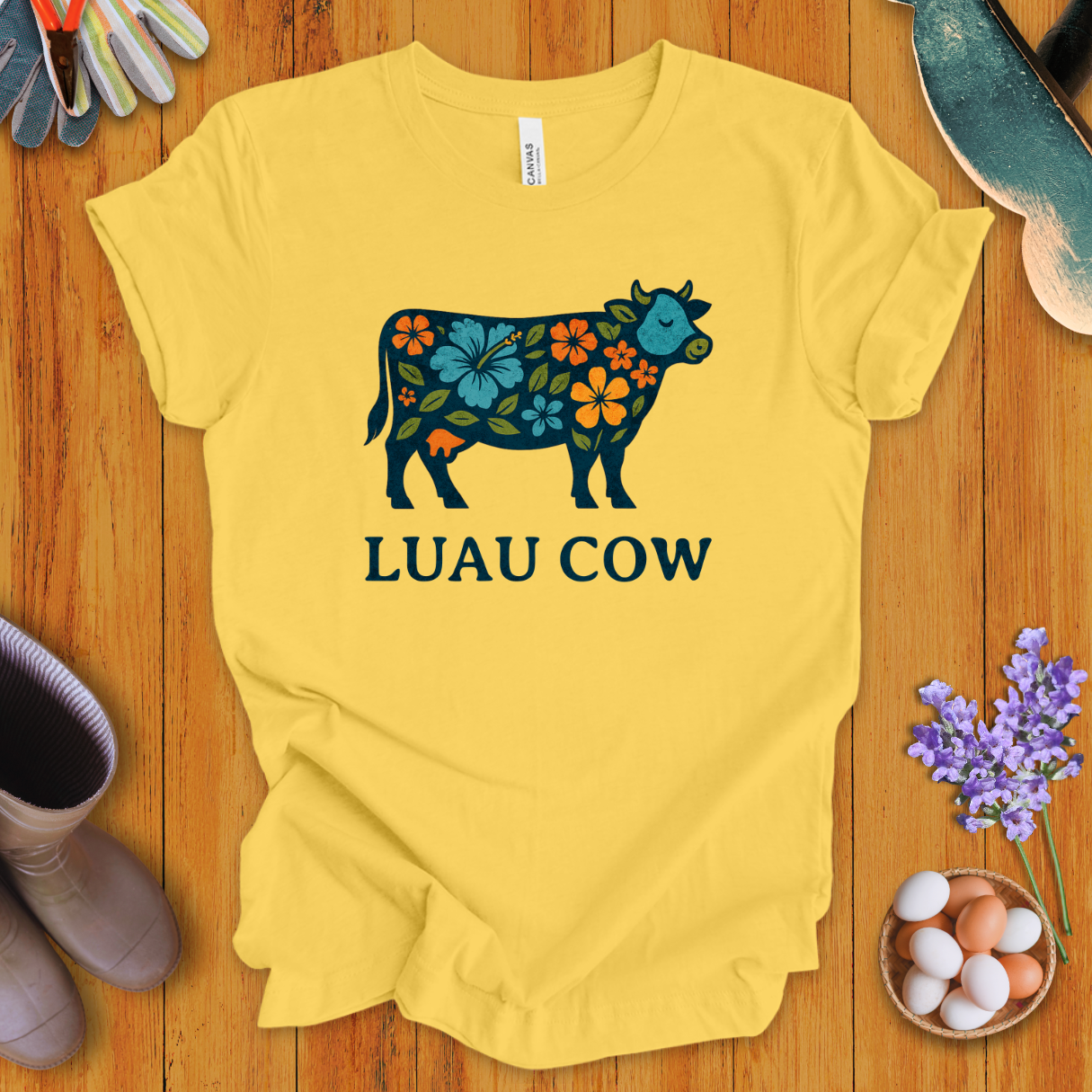 Floral luau cow graphic on yellow t-shirt with bold text “LUAU COW”