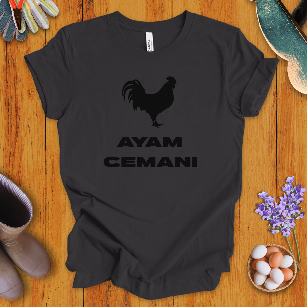 Black Ayam Cemani chicken silhouette on t-shirt with bold text “AYAM CEMANI”